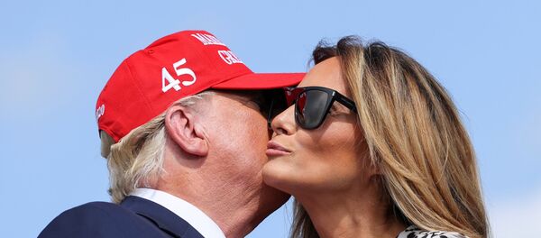 الرئيس الأمريكي دونالد ترامب يقبل زوجته ميلانيا ترامب أثناء حملة انتخابيا في فلوريدا، 29 أكتوبر/ تشرين الأول 2020 - سبوتنيك عربي