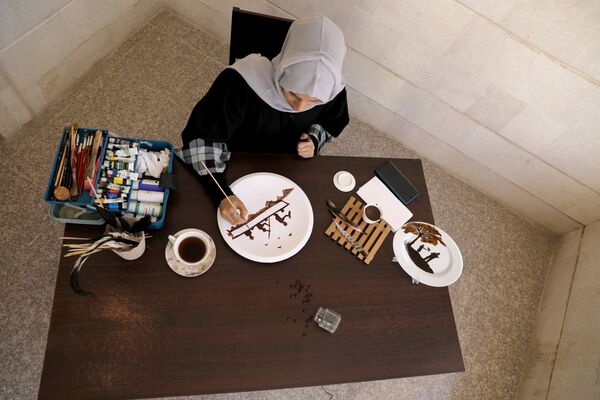 الفنانة اليمنية أحلام ناصر ترسم ببن القهوة في منزلها بمدينة صنعاء، اليمن 23 نوفمبر 2020 - سبوتنيك عربي