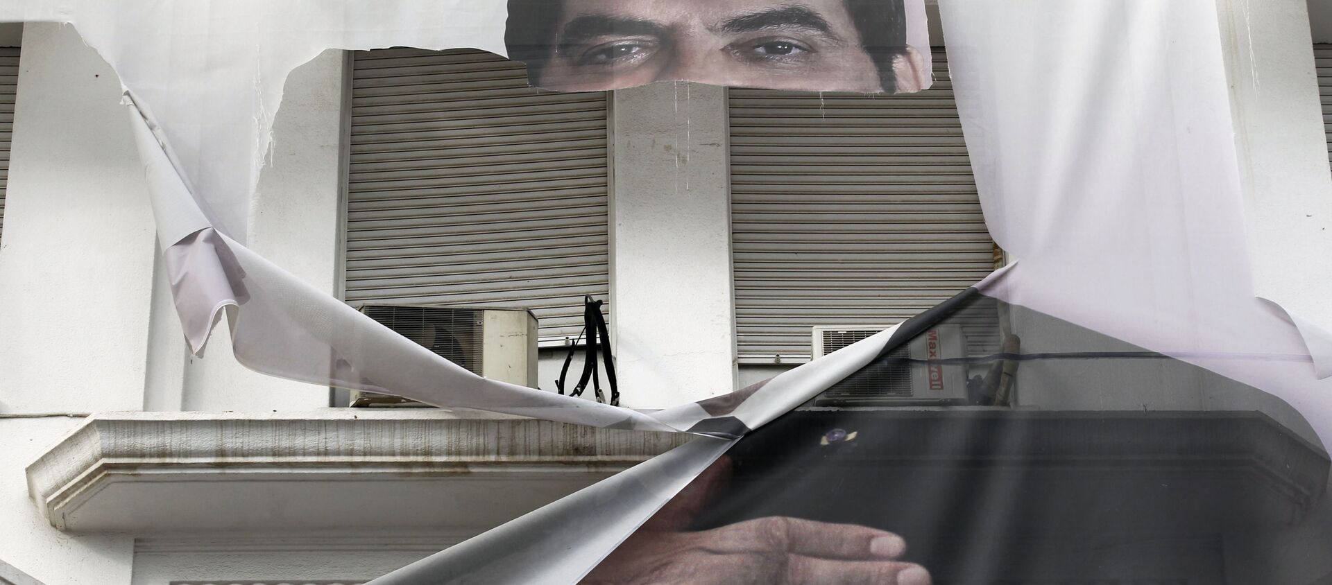 لافتة ممزقة للرئيس التونسي الأسبق زين العابدين بن علي وسط العاصمة تونس، 16 يناير 2011 - سبوتنيك عربي, 1920, 23.03.2021