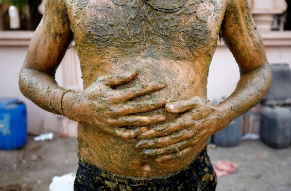 هنديون يلجأون إلى روث الأبقار كوسيلة للوقاية من المرض كوفيد-19 الذي يسببه فيروس كورونا، ضواحي أحمد آباد، الهند، 9 مايو 2021 - سبوتنيك عربي