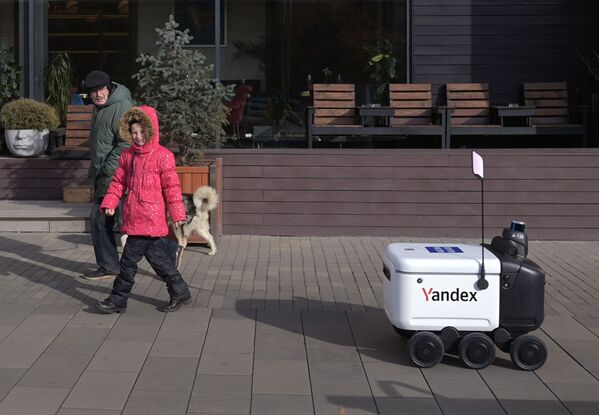 روبوت لتوصيل طلبات من Yandex ينقل طرود البريد الروسي في أحد شوارع موسكو الوسية، 26 أكتوبر 2021 - سبوتنيك عربي