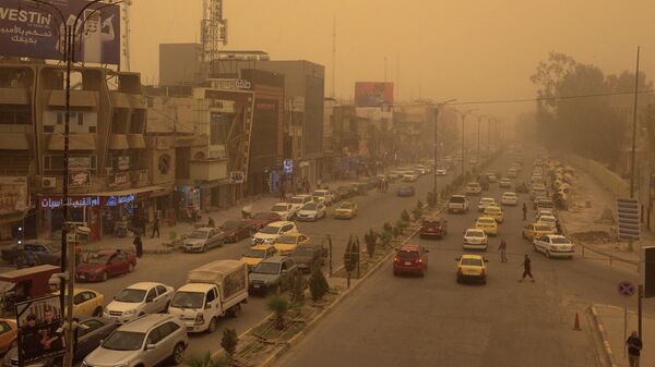 السيارات تسير وسط عاصفة رملية على طريق رئيسي في مدينة الموصل شمال العراق، في 7 أبريل 2022. - سبوتنيك عربي