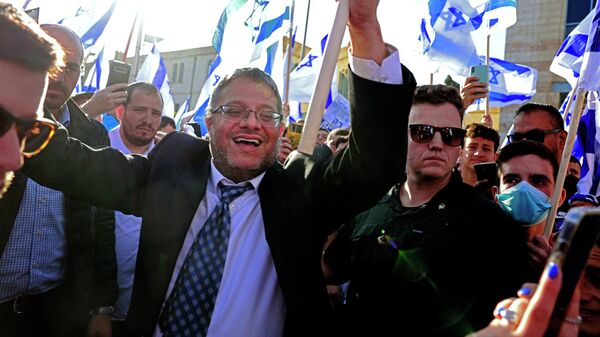 زعيم حزب عوتسما يهوديت إيتامار بن غفير، يرفع العلم الإسرائيلي في القدس في 20 أبريل 2022 ، في بداية مسيرة الأعلام التي نظمتها الأحزاب القومية - سبوتنيك عربي