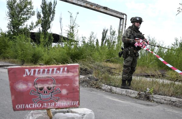 جندي من المركز الدولي للأعمال المتعلقة بإزالة الألغام التابع للقوات المسلحة الروسية يقوم باكتشاف وإزالة الألغام على أراضي مصنع آزوفماش في ماريوبول، 27 أغسطس 2022 - سبوتنيك عربي