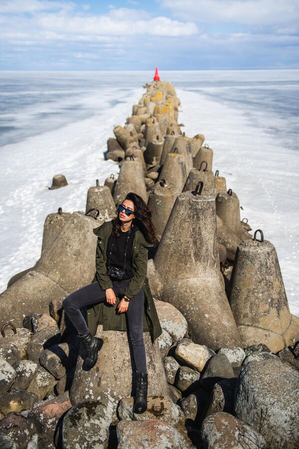 فتاة على الأسوار الحجرية في مدينة بيلوزيرسك الروسية.يعود أول ذكر للمدينة في حكاية السنوات الماضية إلى عام 862، مما يجعل بيلوزيورسك واحدة من أقدم المدن في روسيا.  بحيرة "بيلويه" (بالروسية تعني أبيض) هي سابع أكبر بحيرة في أوروبا. هناك العديد من الإصدارات حول أصل الاسم، ولكن هناك حقيقة طبيعية: الجزء السفلي من الخزان مغطى بالطين الأبيض، والذي يشكل تعليقًا أثناء العاصفة. لذلك نرى المياه "البيضاء" في البحيرة. هنا بإمكان السائح أن يشحن طاقته من طبيعة الشمال الروسي العريق، ويستمتع بصيد الأسماك. - سبوتنيك عربي