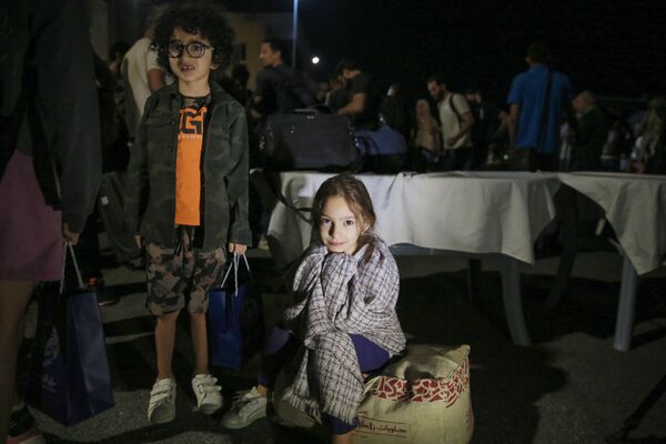 أطفال تم إجلاؤهم من السودان ينتظرون بعد وصولهم إلى مطار عسكري في عمان في 24 أبريل 2023.  - سبوتنيك عربي