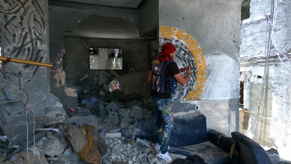 فنان فلسطيني يرسم لوحات فنية داخل المباني المدمرة بفعل الغارات الإسرائيلية على قطاع غزة
 - سبوتنيك عربي