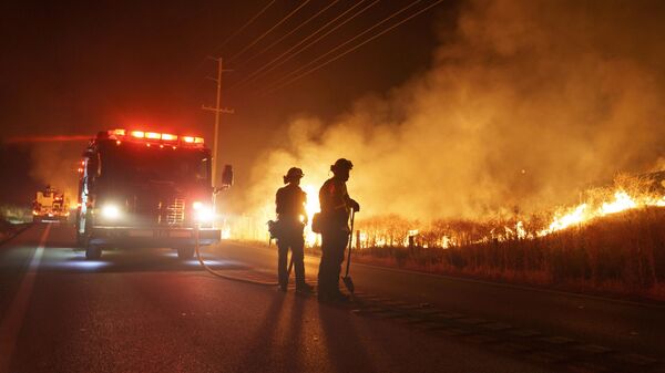 Пожарные наблюдают за пожаром, в Морено-Вэлли, Калифорния, США - سبوتنيك عربي