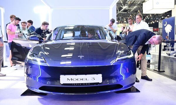 زوار يتفقدون سيارة Tesla model 3 معروضة في معرض ألمانيا الدولي للسيارات في ميونيخ، 4 سبتمبر 2023. - سبوتنيك عربي
