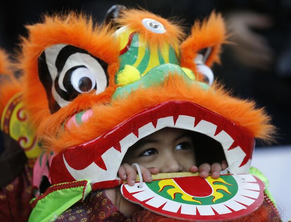 أطفال يرتدون زي تنين يؤدون عرضًا بمناسبة العام الصيني الجديد في منطقة الحي الصيني في لندن، الأحد 18 فبراير 2018. - سبوتنيك عربي