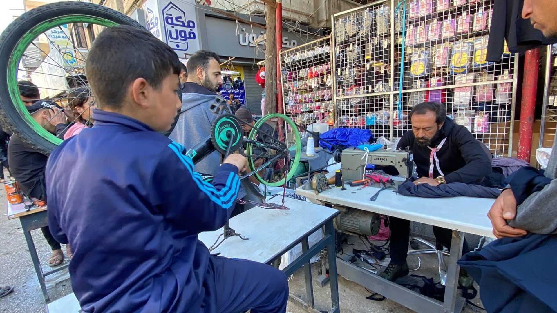 فلسطيني يستعين بدراجة هوائية ليحيك ملابس للنازحين من تدوير الأقمشة المهترئة - سبوتنيك عربي, 1920, 07.02.2024