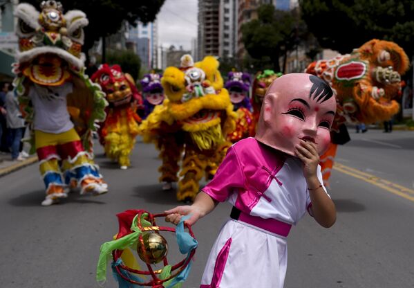 شاب يرتدي قناعا خلال مشاركته في احتفالات السنة القمرية الصينية الجديدة في لاباز، بوليفيا. - سبوتنيك عربي