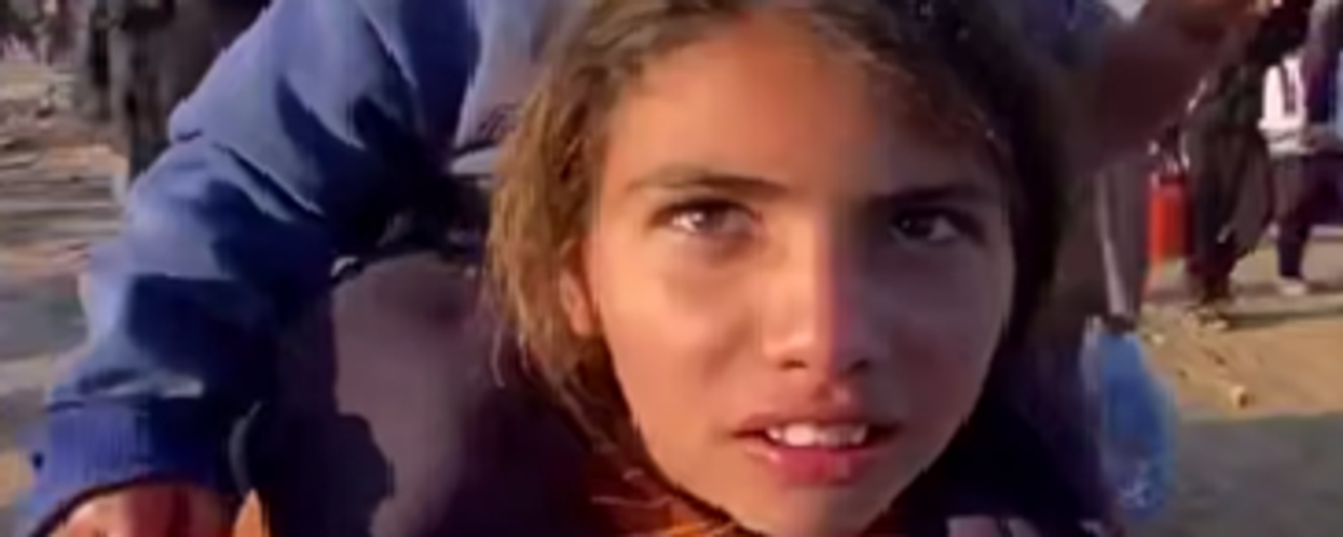 صورة لطفلة فلسطينية تحمل شقيقتها أثناء عودتهم إلى شمال قطاع غزة  - سبوتنيك عربي, 1920, 27.01.2025