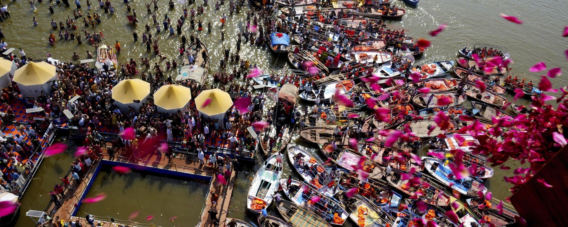 مسؤولون حكوميون يمطرون بتلات الزهور من طائرة هليكوبتر على الحجاج المتجمعين في سانجام، ملتقى ثلاثة أنهار، نهر الجانج، ويامونا، وساراسواتي الأسطورية، في ماغي بورنيما أو يوم اكتمال القمر خلال مهرجان ماها كومبه في براياجراج، الهند، الأربعاء 12 فبراير 2025. - سبوتنيك عربي, 1920, 18.02.2025