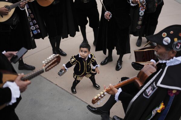 صورة لطفل يبلغ من العمر عاما واحدا، يرقص مع فرقة موسيقية قبل احتفال "سينكو دي مايو" في مارياتشي بلازا في لوس أنجلوس. - سبوتنيك عربي