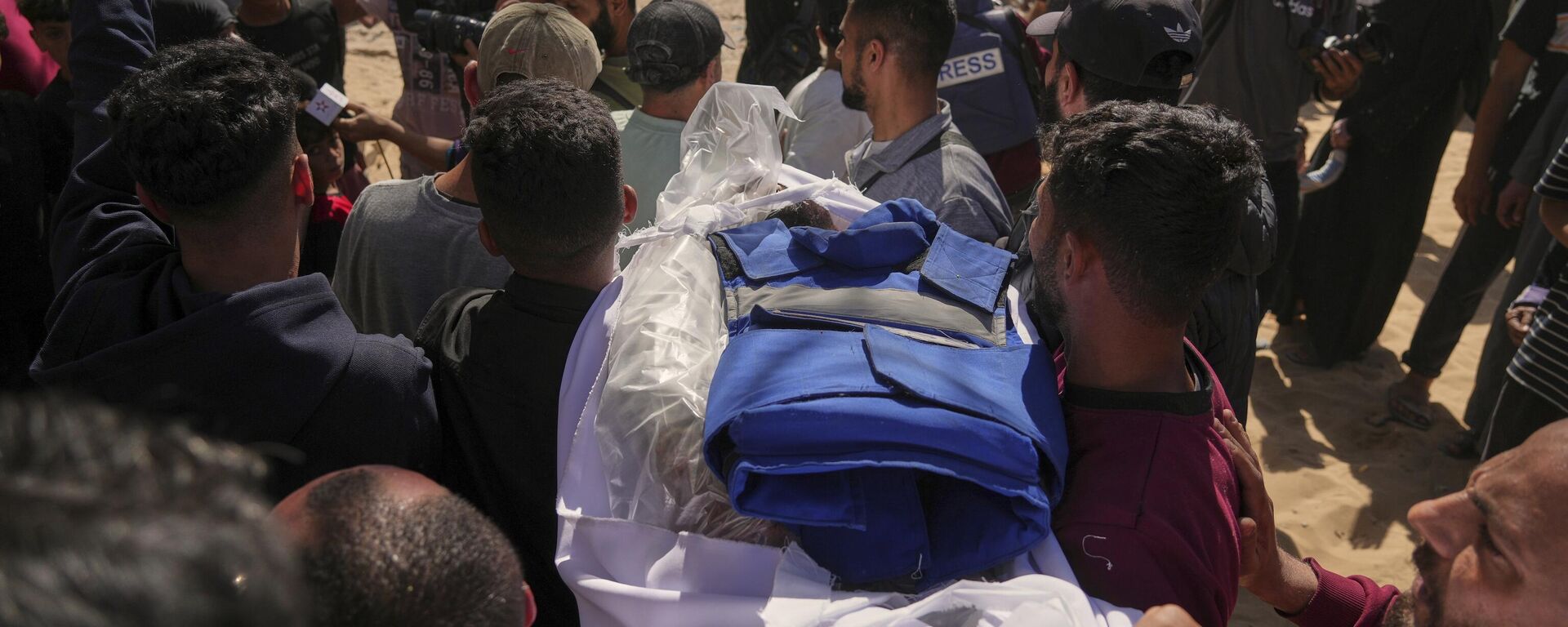 نقل جثمان الصحفي الفلسطيني يحيى صبيح، الذي قُتل مع 28 آخرين على الأقل في غارة للجيش الإسرائيلي على مطعم، إلى مستشفى الشفاء في مدينة غزة، الأربعاء 7 مايو/أيار 2025. - سبوتنيك عربي, 1920, 18.05.2025