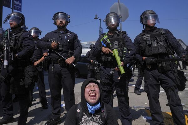 أحد المتظاهرين يصرخ أثناء مواجهة عناصر الشرطة لهم. - سبوتنيك عربي