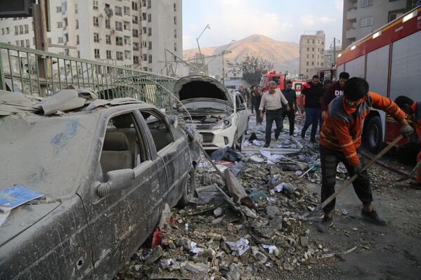 منظر لمبنى متضرر في العاصمة الإيرانية طهران، إثر هجوم إسرائيلي، في 13 يونيو/حزيران 2025، وفرق الإطفاء تُرسل إلى المنطقة. - سبوتنيك عربي