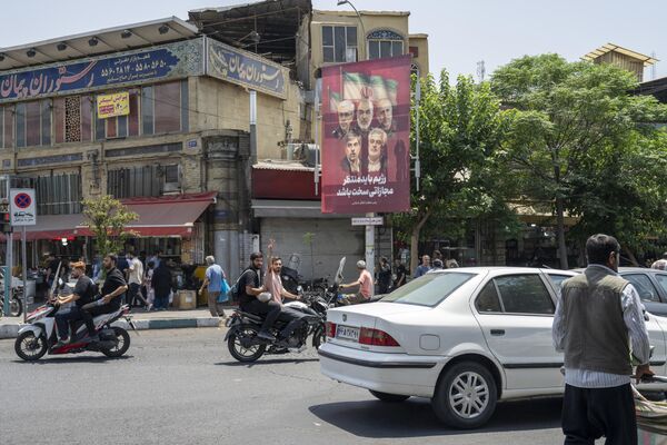 حركة سير وأشخاص يسيرون على طول الشارع أمام سوق طهران المغلق جزئيًا بعد الساعات الأولى من شن الولايات المتحدة الأمريكية هجوما على 3 منشآت نووية إيرانية في نطنز وفوردو وأصفهان، ليلة 22 يونيو - سبوتنيك عربي
