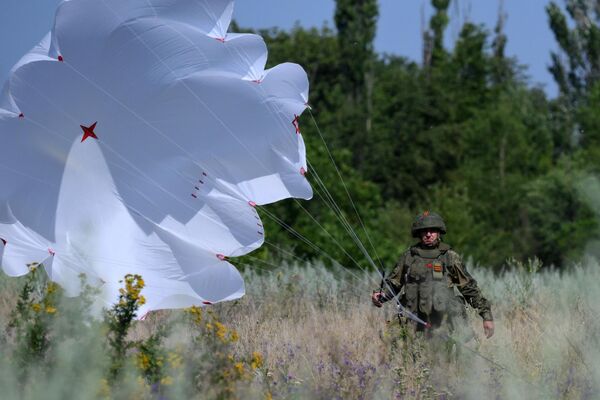 جندي روسي يلتقط طائرة الاستطلاع المسيرة الروسية "أورلان-10"، لحظة هبوطها - سبوتنيك عربي