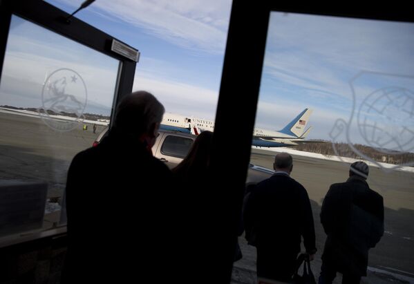 أعضاء فريق وزير الخارجية الأمريكي السابق جون كيري، يتجهون إلى الطائرة بعد توقف للتزود بالوقود في قاعدة إلميندورف الجوية، في أنكوريج في ولاية ألاسكا، في فبراير/شباط 2014. - سبوتنيك عربي