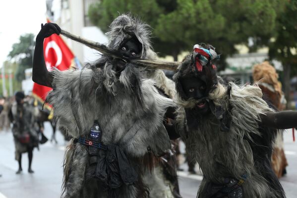 فنانون يرتدون زي "تولوتاباك" (زي من جلود الأغنام والماعز) خلال احتفالات الذكرى الثالثة بعد المائة لتحرير باليكسير، تركيا. - سبوتنيك عربي