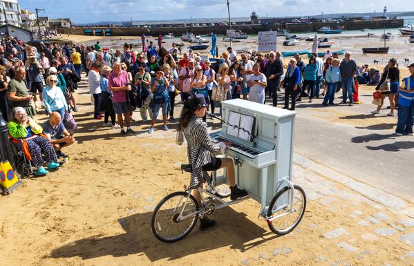 حشود تتوافد لمشاهدة عازفة البيانو المتجولة في مهرجان سانت آيفز، إنجلترا. - سبوتنيك عربي