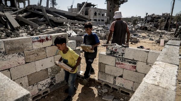 عائلة الغصين تبدأ بإعادة بناء منزلها المدمر في حي الشيخ رضوان شمال مدينة غزة، بعد انسحاب جيش الاحتلال الإسرائيلي من المدينة. - سبوتنيك عربي