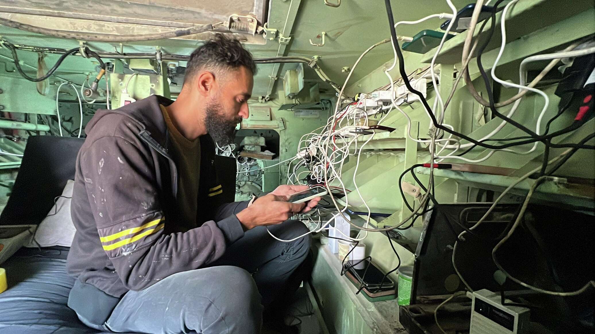 فلسطيني يحول بقايا مدرعة إسرائيلية إلى محطة شحن هواتف في غزة