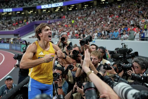 يحتفل السويدي، أرماند دوبلانتيس، بعد أن حقق إنجازا بتجاوزه الرقم القياسي العالمي عقب فوزه بالميدالية الذهبية في نهائي مسابقة القفز بالزانة للرجال في بطولة العالم لألعاب القوى في طوكيو - سبوتنيك عربي