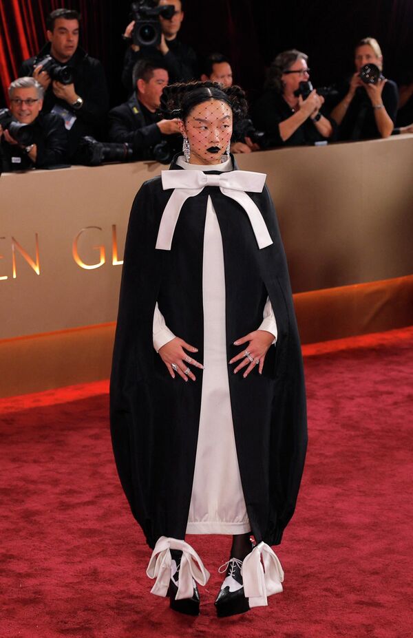 أودري نونا تلفت الأنظار بفستان أسود وأبيض مزيّن بربطات بيضاء، خلال التقاط الصور لها على السجادة الحمراء. - سبوتنيك عربي