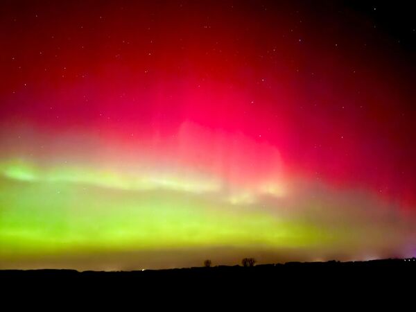 صورة لأضواء الشفق القطبي الشمالي بألوانه البارقة متمثلًا باللونين الأصفر والأحمر، في ساكسونيا، أنهالت، ألمانيا - سبوتنيك عربي