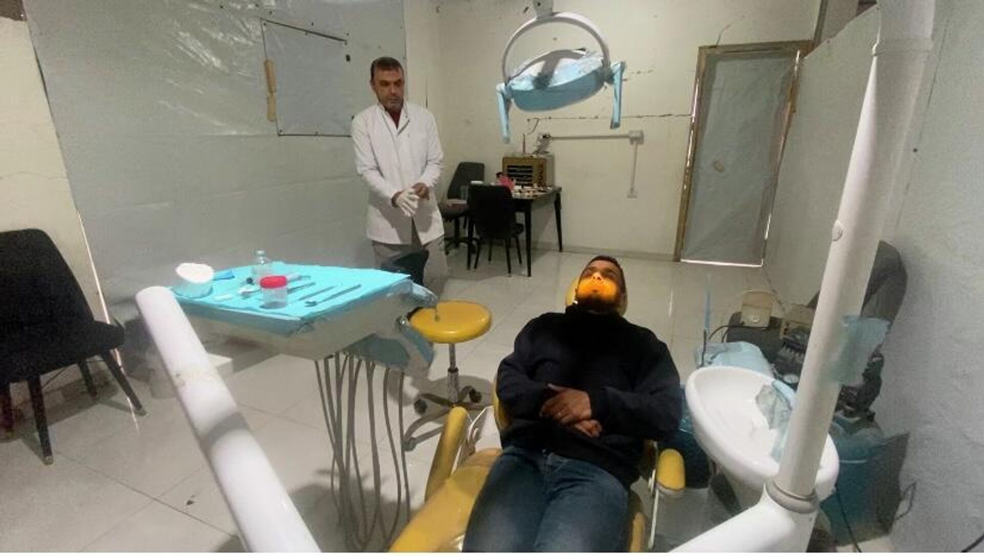 طبيب أسنان يعالج المرضى بين أنقاض منزله المدمر في غزة   - سبوتنيك عربي, 1920, 10.02.2026