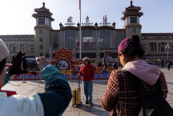 الناس تتجهز للعام الصيني الجديد أمام محطة السكة الحديدية في بكين - سبوتنيك عربي