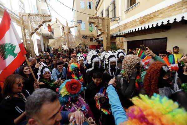 كرنفال "الزامبو" يسير في أحد شواع مدينة الميناء، وسط جموع من اللبنانيين الذي اصطفوا على جانبي الطريق وهم يشاهدون الكرنفال بإعجاب . - سبوتنيك عربي