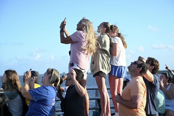 أشخاص يقفون على جسر أ. ماكس بروير، ويوثقون بعدسات أجهزتهم المحمولة، إطلاق صاروخ "أرتميس 2" إلى القمر. - سبوتنيك عربي