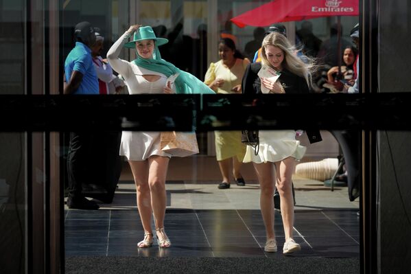 رواد سباق الخيل يصلون إلى المدرج الرئيسي قبل انطلاق سباق كأس دبي العالمي في ميدان سباق الخيل في دبي، الإمارات العربية المتحدة. - سبوتنيك عربي