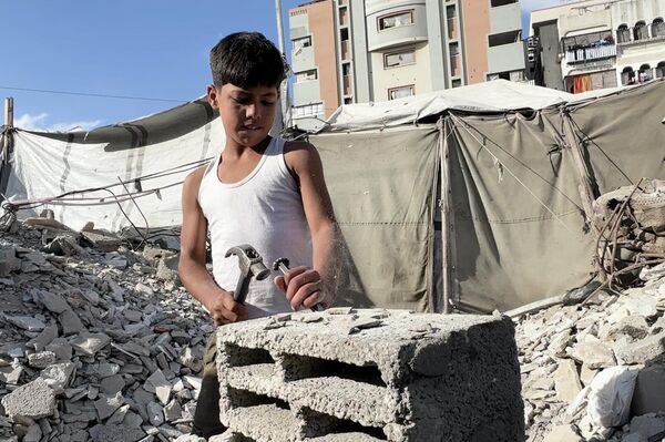 طفل فلسطيني يحمل المطرقة بدل القلم ويعمل في البناء لتأمين طعام عائلته مايو 2026  - سبوتنيك عربي