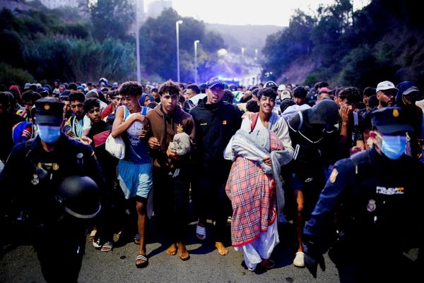 الشرطة تنقل مئات المهاجرين إلى منشأة جديدة عقب العبور الجماعي للمهاجرين من الحدود مع المغرب في سبتة الإسبانية. - سبوتنيك عربي