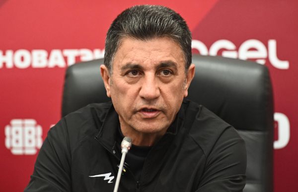 المدرب الرئيسي للمنتخب الإيراني أمير قلعة يظهر جالسًا خلف طاولة تحمل ميكروفونات، وذلك خلال مؤتمر صحفي عقده قبل تدريب الفريق. - سبوتنيك عربي