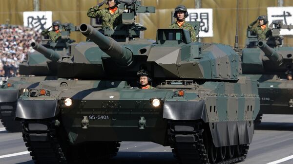 FILE - In this Oct. 27, 2013 file photo, members of the Japan Ground Self-Defense Force salute from Type 90 tanks at a parade during the Self-Defense Forces Day at Asaka Base, north of Tokyo - سبوتنيك عربي