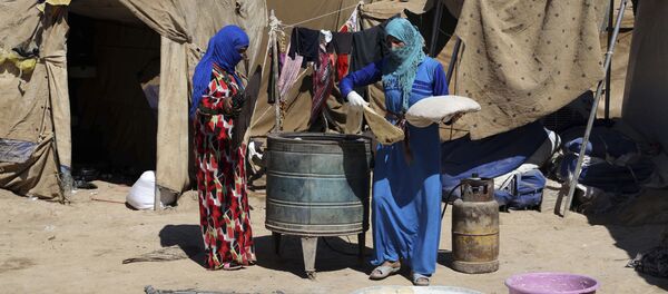 Iraqi women bake bread at al-Takia refugee camp in Baghdad, Iraq, Thursday, Sept. 24, 2015 - سبوتنيك عربي