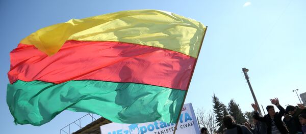 A Kurdish man waves a large flag of the Kurdish People's Protection Units (YPG) political wing, the Democratic Union Party (PYD), during a demonstration against the exclusion of Syrian-Kurds from the Geneva talks in the northeastern Syrian city of Qamishli on February 4, 2016 A Kurdish man waves a large flag of the Kurdish People's Protection Units (YPG) political wing, the Democratic Union Party (PYD), during a demonstration against the exclusion of Syrian-Kurds from the Geneva talks in the northeastern Syrian city of Qamishli on February 4, 2016 - سبوتنيك عربي