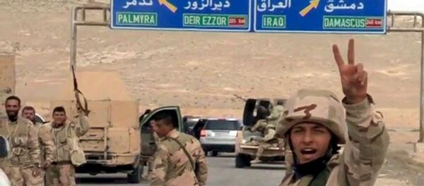 Forces loyal to Syria's President Bashar al-Assad gesture as they advance into the historic city of Palmyra in this picture provided by SANA on March 24, 2016. Forces loyal to Syria's President Bashar al-Assad gesture as they advance into the historic city of Palmyra in this picture provided by SANA on March 24, 2016. - سبوتنيك عربي