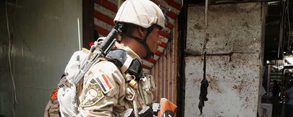 أحد أفراد الأمن العراقي أثناء تفقد انفجار بغداد - سبوتنيك عربي