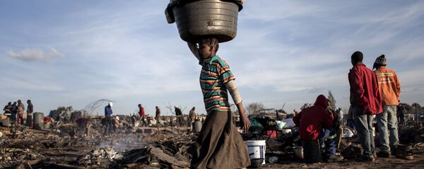 امرأة تحمل على رأسها كل ما تبقى من بعد حريق في بيتوريا، جمهورية جنوب أفريقيا 3 يوليو\ تموز 2016 - سبوتنيك عربي