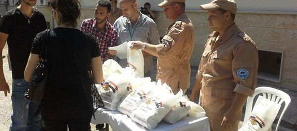 مساعدات انسانية روسية سورية مشتركة في ريف حمص الغربي - سبوتنيك عربي