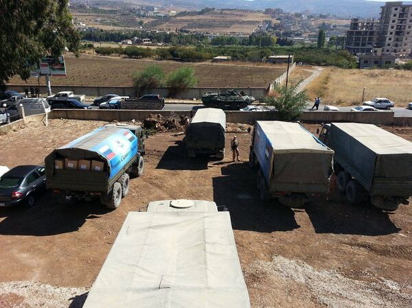 مساعدات انسانية روسية سورية مشتركة في ريف حمص الغربي  - سبوتنيك عربي