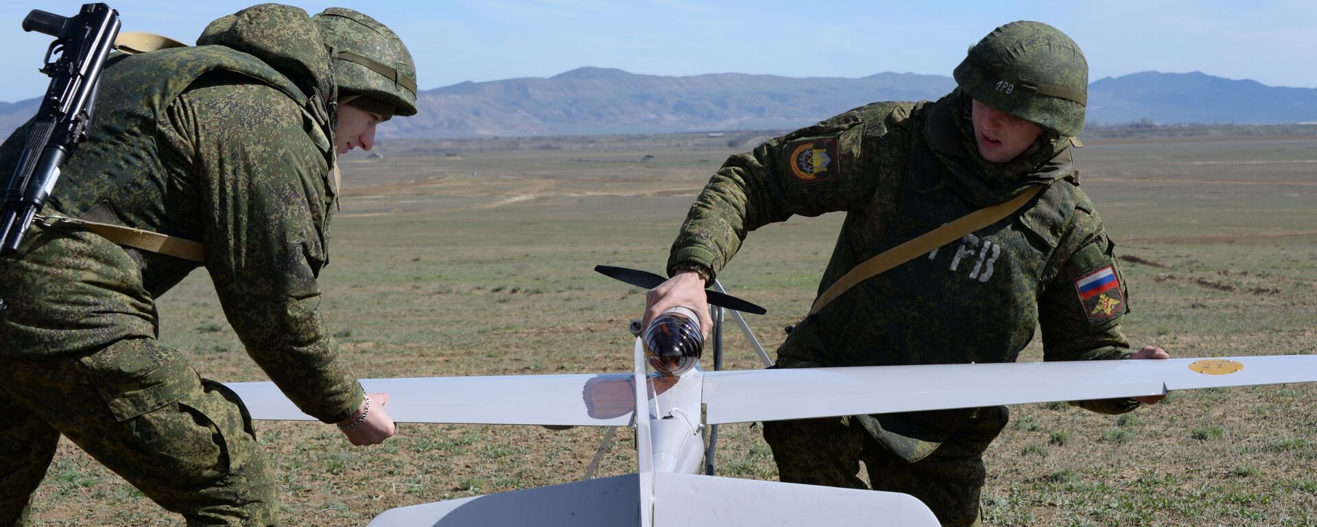 الجنود يعدون طائرة دون طيار للتحليق خلال مناورات قوات الدائرة العسكرية الشرقية في حقل الرمي دالنيي في منطقة بويناكوفسكي - سبوتنيك عربي, 1920, 24.01.2025