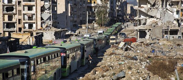 الحافلات الخضراء تنقل المسلحين وأفراد أسرهم لمغادرة مدينة حلب ، 15 ديسمبر/ كانون الأول 2016 - سبوتنيك عربي